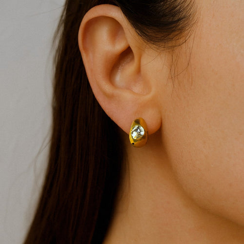 Gold Huggie Earrings with Moissanite, Chunky Dome Hoops in 18k Gold Plated Sterling Silver, worn on model for scale