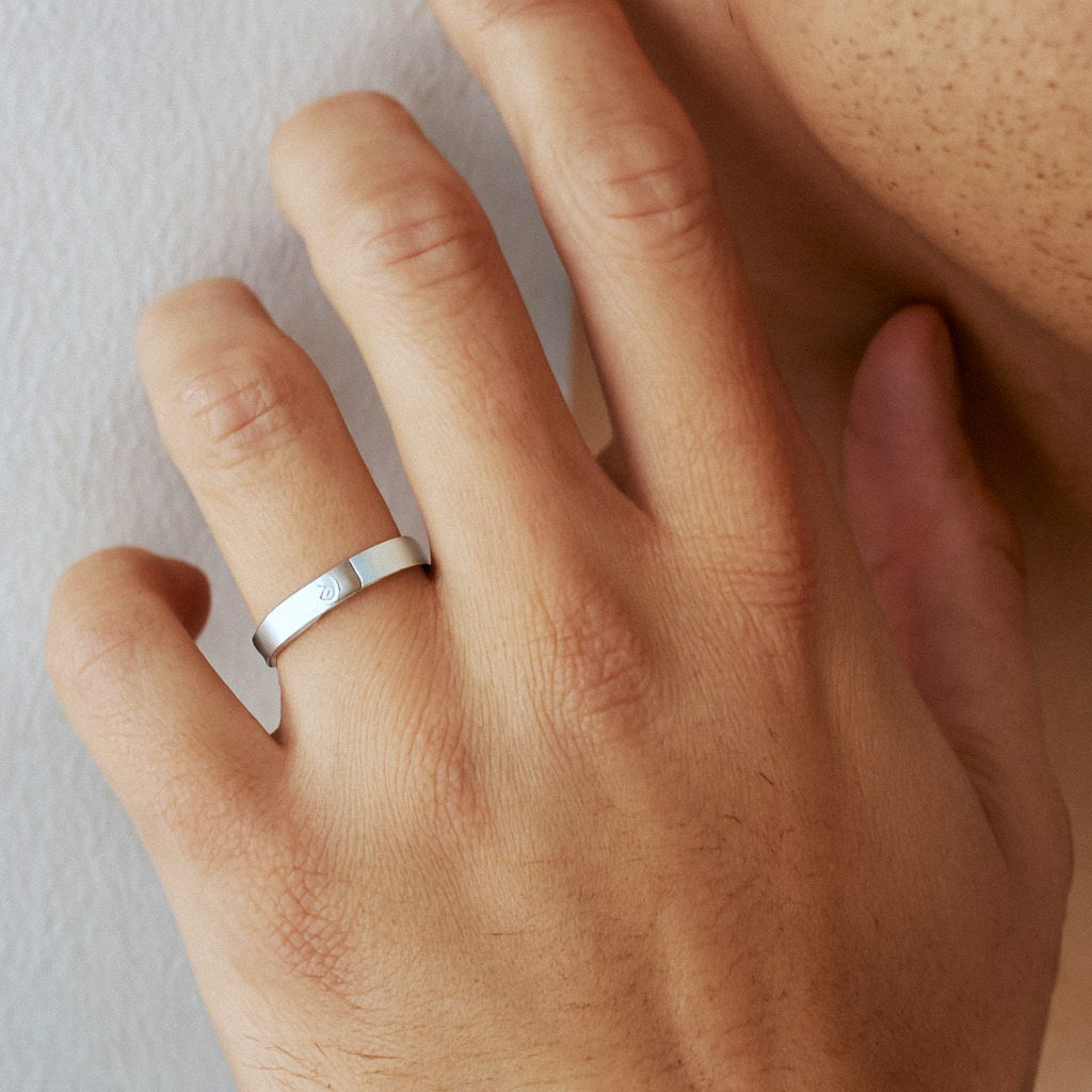 Mens Moissanite Ring, Sterling Silver Band with Flush-Set Stone, worn on model for scale