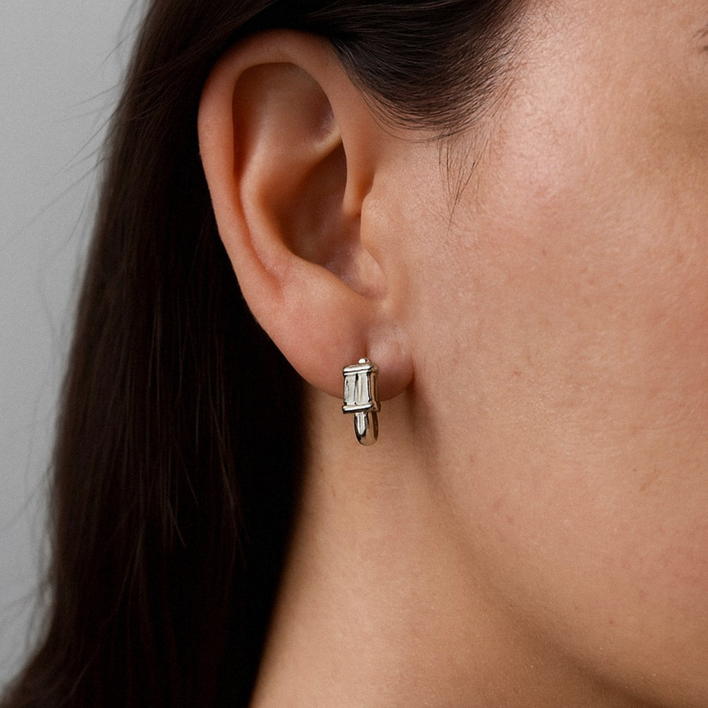Emerald Cut Moissanite Huggie Earrings, 925 Sterling Silver, worn on model for scale
