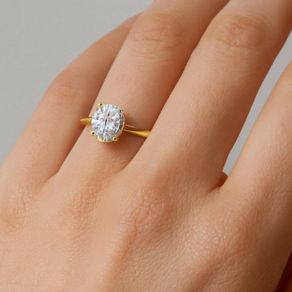 Gold Oval Moissanite Ring, Oval Solitaire Engagement Ring in 18k Gold Plated Sterling Silver, worn on model for scale