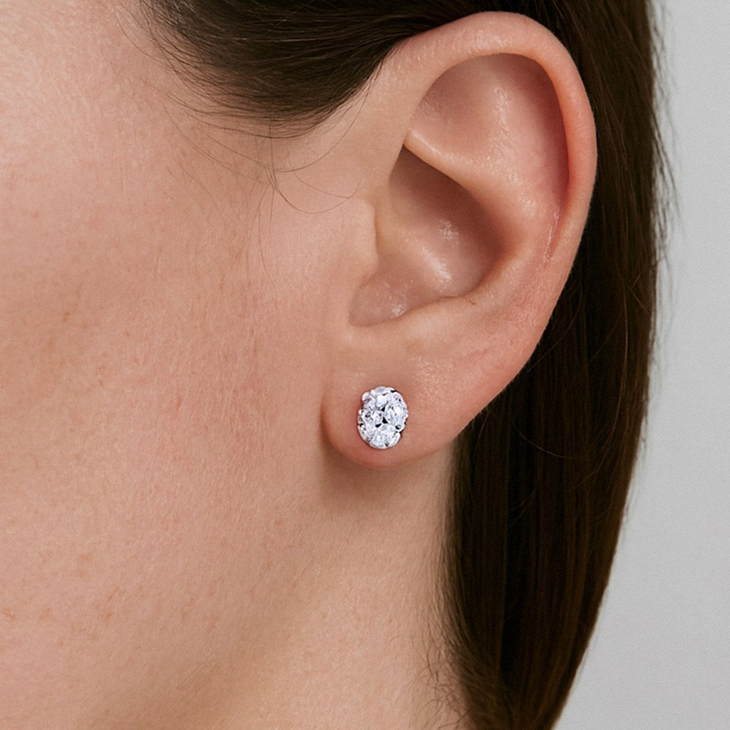Oval Moissanite Stud Earrings, 925 Sterling Silver, worn on model for scale