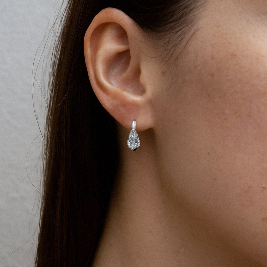 Pear Moissanite Huggie Earrings, 925 Sterling Silver, worn on model for scale