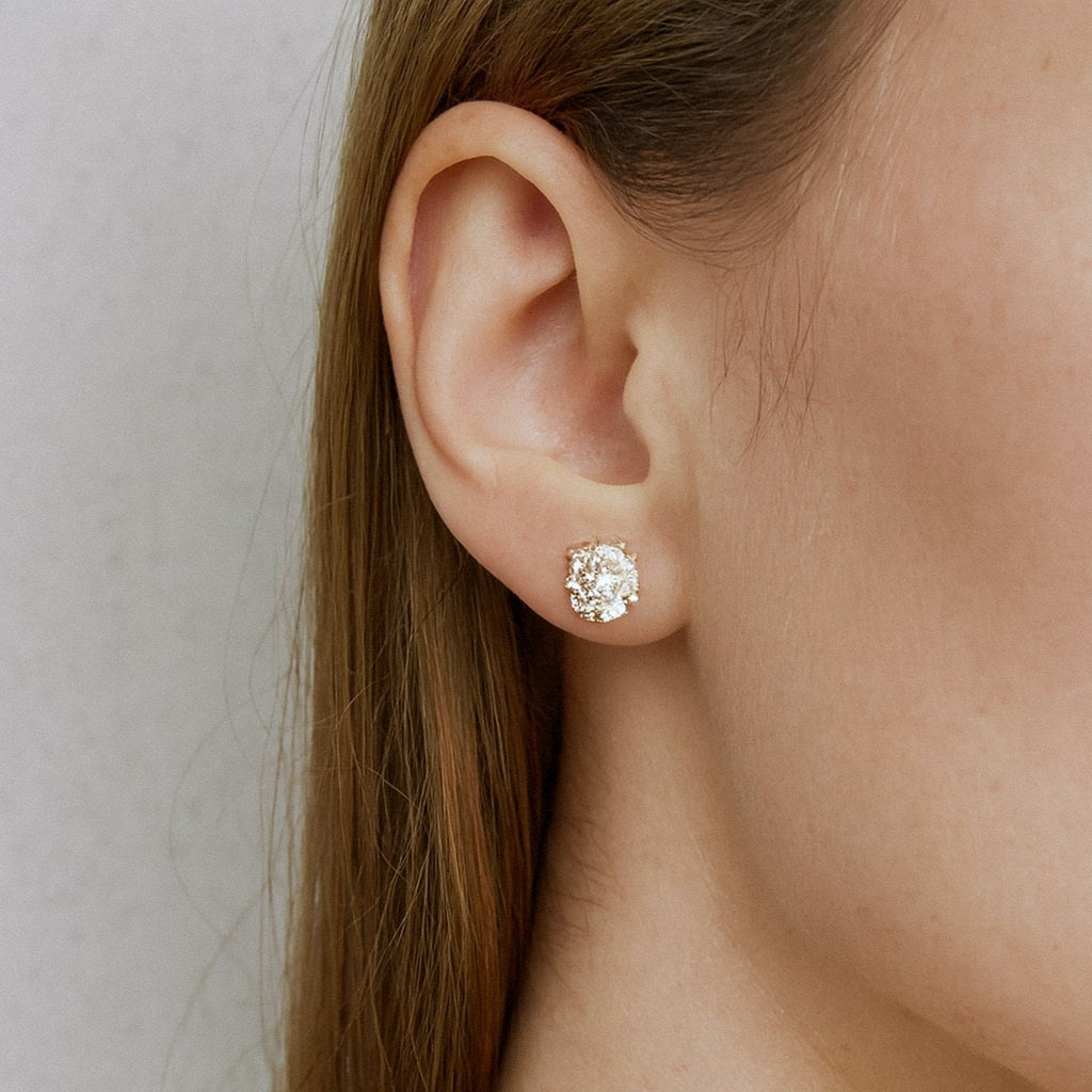 Gold Moissanite Stud Earrings, Four-Prong Studs in 18k Gold Plated Sterling Silver, worn on model for scale