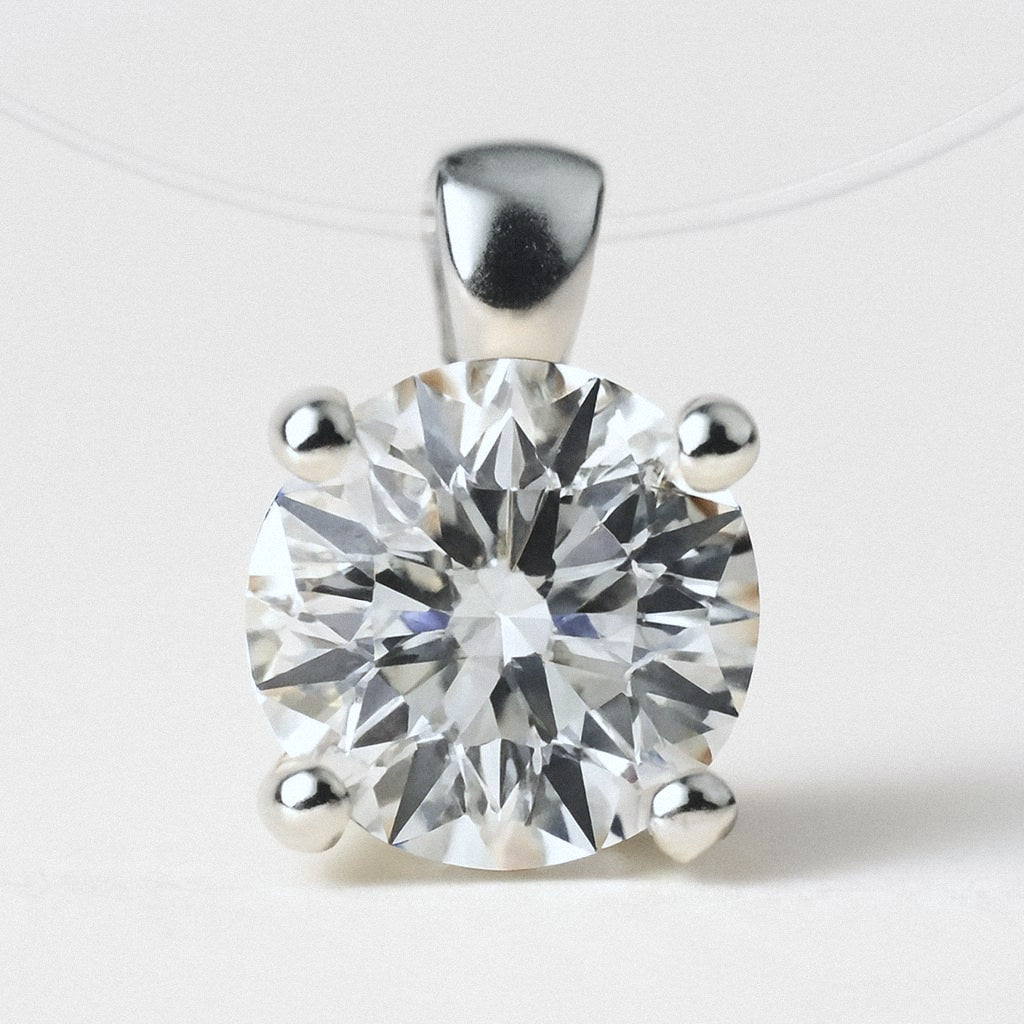 Floating Moissanite Necklace, close-up of the round moissanite in its four-prong sterling silver setting on the clear illusion cord