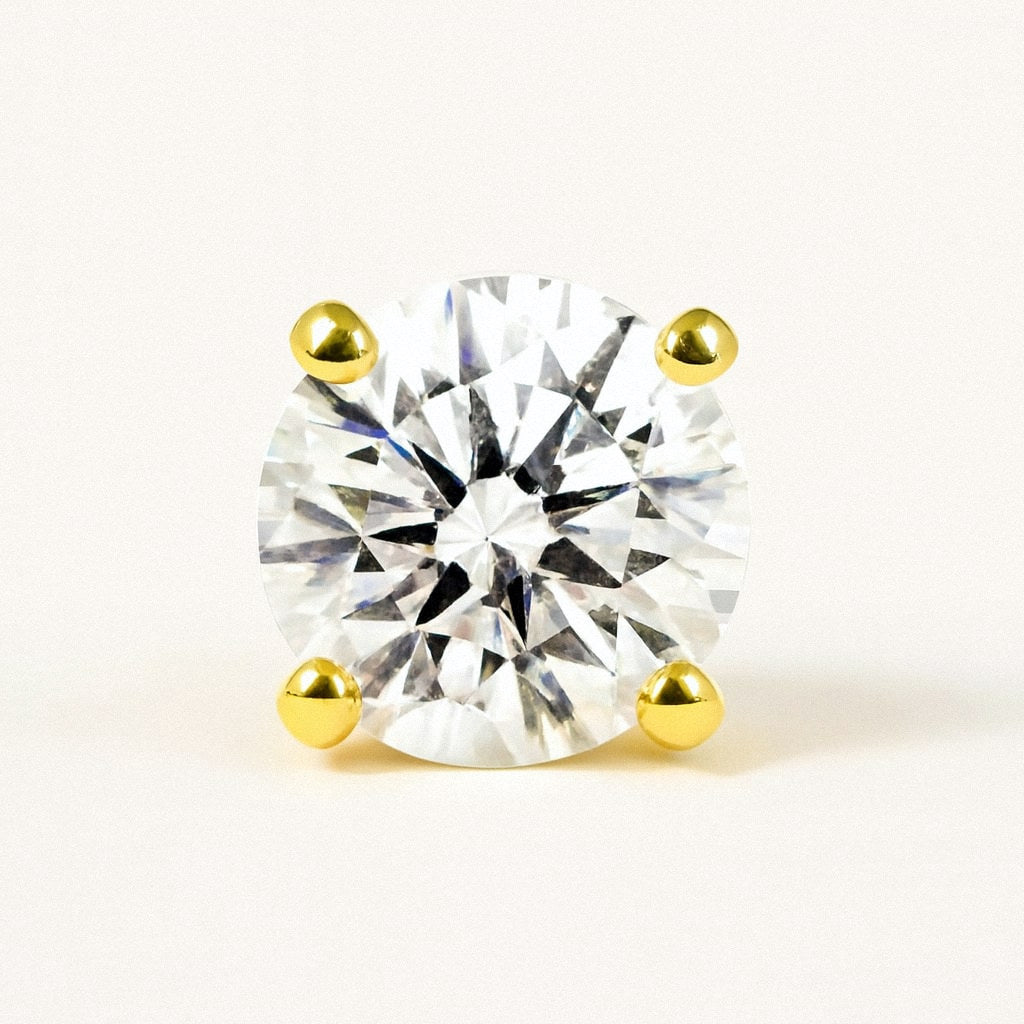 Gold Four-Prong Moissanite Stud Earrings, Gold Plated Sterling Silver, close-up of the round moissanite and four gold prongs