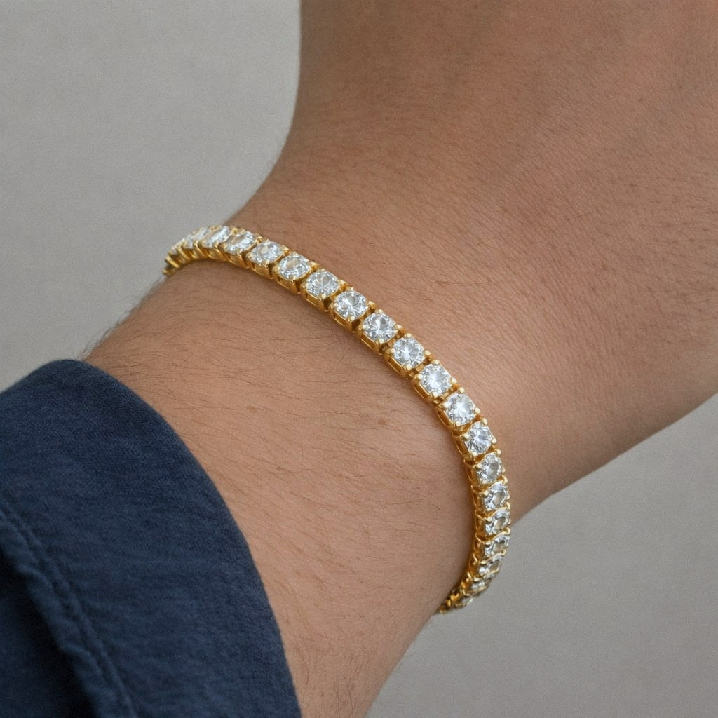 Mens gold moissanite tennis bracelet worn on the wrist for scale