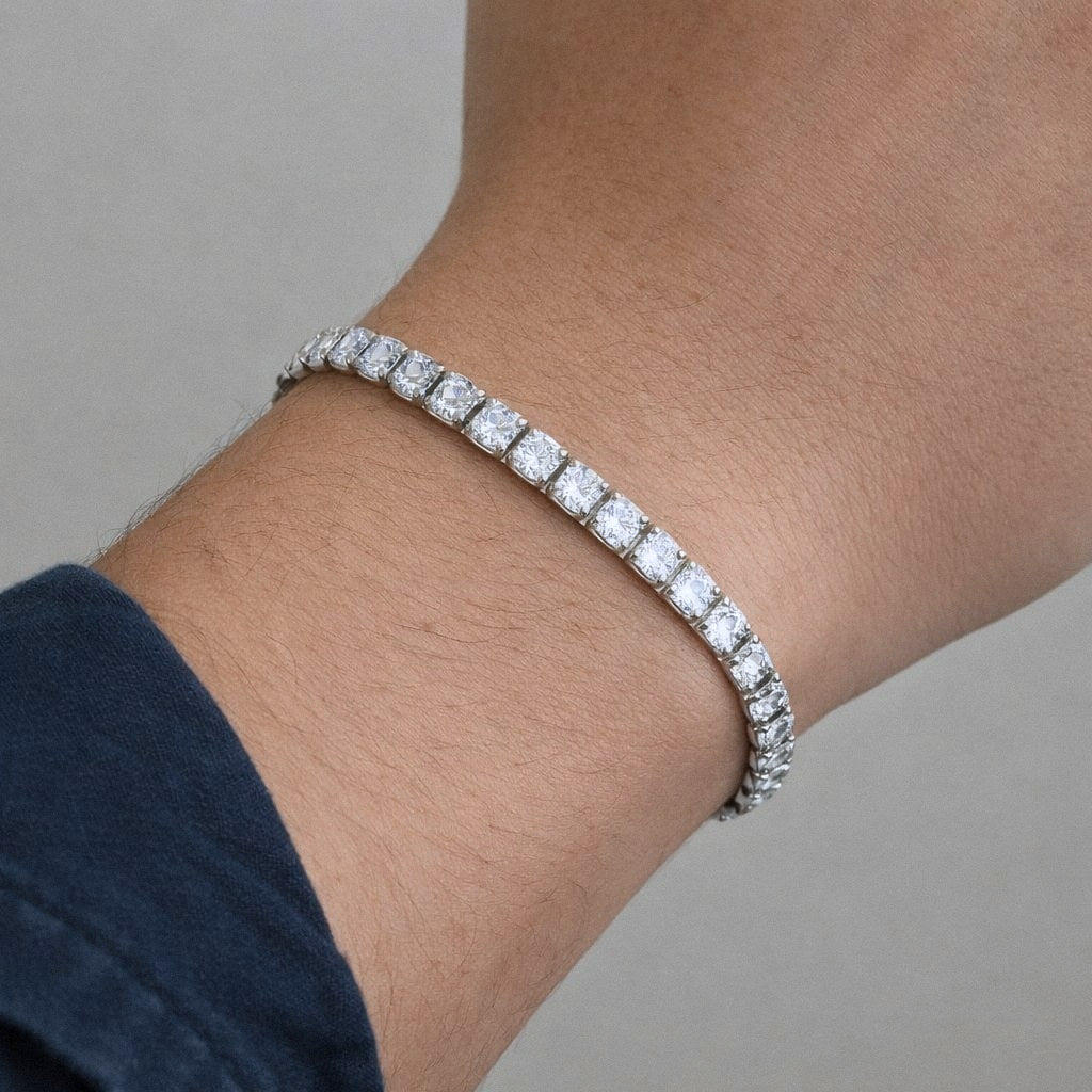 Mens silver moissanite tennis bracelet worn on the wrist for scale